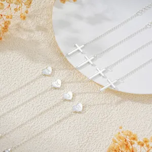 Detailed view of silver cross heart letter charm adjustable bracelet set, exquisite fashion style.