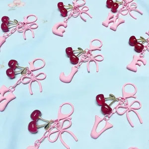 Cute pink cherry letter keychain and adorable bow bag charm for stylish women accessory