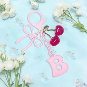 Cute pink cherry keychain and letter B bag charm with bow, sweet accessory for women and keys.