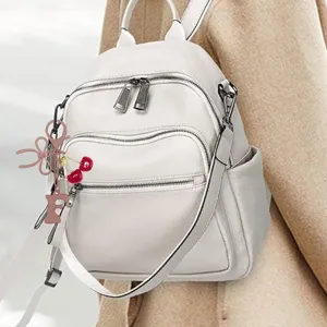 Cute cherry and bow bag charm keychain, stylish accessory for women backpacks and handbags.