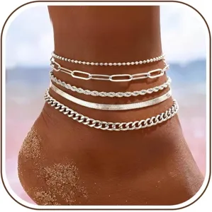 Silver layered anklets detail close up, featuring five different chain styles for beach wear.