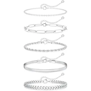 Set of 5 silver stainless steel anklets for women, minimalist Cuban and snake chain styles.