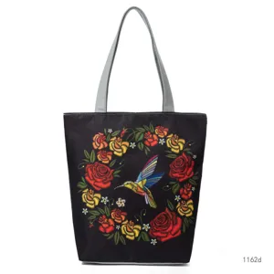 Black tote bag with colorful rose wreath and bird embroidery, grey straps, large capacity.