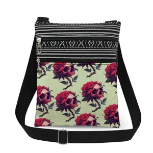 Close-up detail of the gothic skull and rose print canvas crossbody shoulder bag.