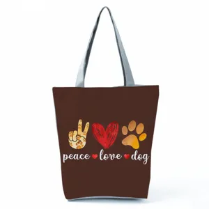 Borsa shopper marrone in tela con stampa di zampe di cane, grande borsa a tracolla casual.
