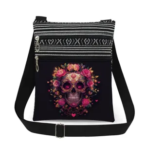 Close up of black canvas crossbody bag featuring colorful sugar skull floral print detail.