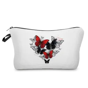 Detail view of white cosmetic pouch featuring a striking red and black butterfly heart print design.