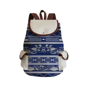 Blue and white porcelain style printed backpack with brown leather trim and multiple pockets for travel.