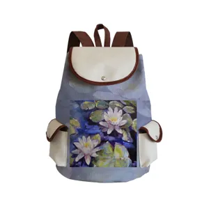 Close-up detail of the canvas backpack featuring art print, beige flap and functional side pockets.
