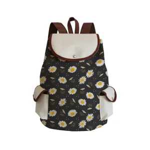 Detailed view of the daisy floral print backpack with contrast canvas flap and straps.