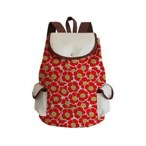 Detailed view of canvas backpack featuring vibrant red floral pattern and brown straps.