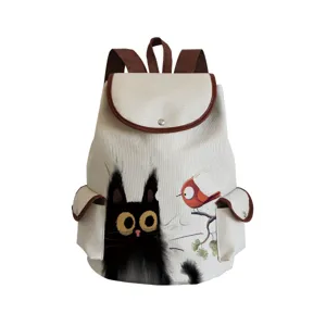 Sac à dos en toile avec imprimé artistique de chat noir et oiseau rouge et finitions en cuir.