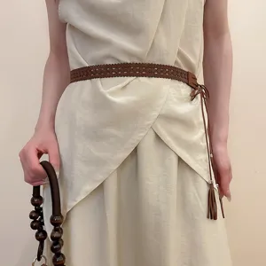 Boho woven waist belt with delicate tassels and chic wooden bead handle for elegant daily outfits.
