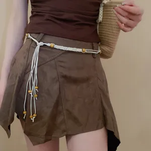 Bohemian woven waist belt with natural wooden beads, stylish cord waist chain accessory detail.
