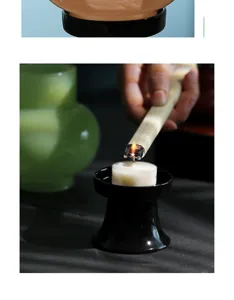 Gros plan sur la base de bougeoir en céramique noire avec bougie, déco de table à thé.