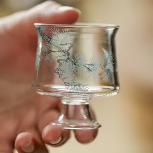 Handmade high-foot glass tea cup with elegant pine tree pattern for kung fu tea tasting master.