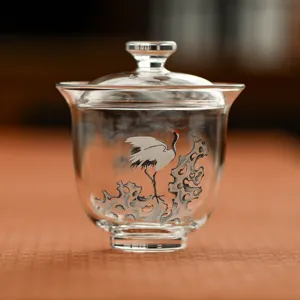 Clear glass tea gaiwan with traditional crane and pine tree painting, perfect for home Kung Fu tea.