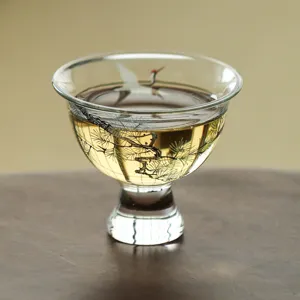 Elegant glass teacup with pine and crane pattern, perfect for traditional kung fu tea tasting.