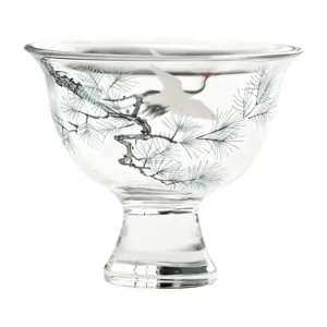 Crystal clear glass tea cup featuring beautiful pine and crane pattern for Kung Fu tea.