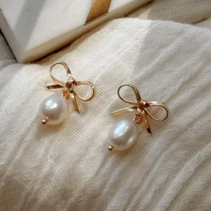 Elegant gold bow earrings with pearl drops for women, chic alloy jewelry gift for friends.