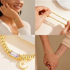 Gold initial birthstone bracelet with purple crystal and letter charm for women and girls.