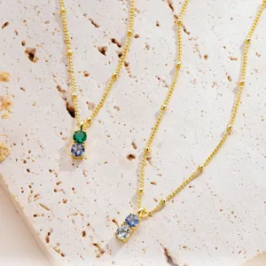 Exquisite double birthstone necklace in gold-plated finish with dainty satellite chain display.