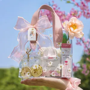 Transparent PVC gift tote bag with daisy patterns, pink leather handle and ribbon bow