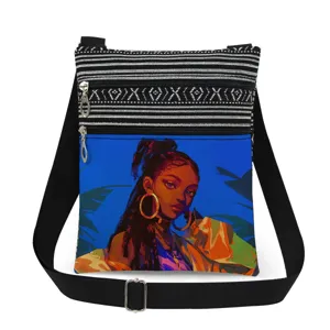 Detailed view of black girl print crossbody bag, double zipper pockets and adjustable strap