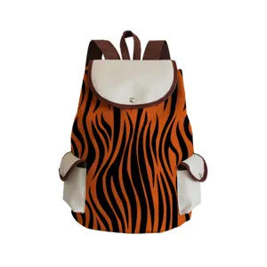 Detail view of the stylish orange tiger stripe backpack with contrast white pockets and brown straps.