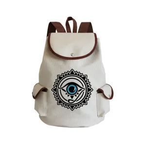 Canvas backpack with unique eye print graphic detail, brown trim accents and double shoulder straps.