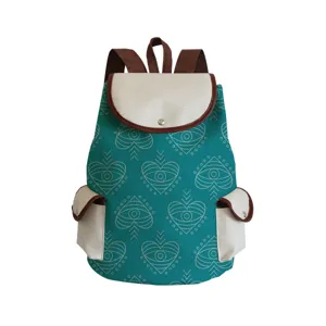 Canvas backpack with unique eye heart print pattern, brown trim and double straps detail.