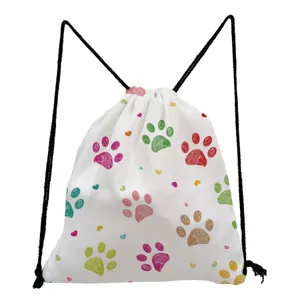 Closeup of white drawstring backpack featuring colorful paw prints and hearts pattern.