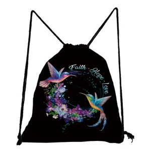 Close-up detail of black drawstring backpack featuring hummingbird floral print and faith text.