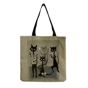 Detailed view of canvas tote bag with retro cat art print and black shoulder straps