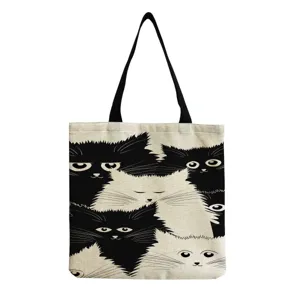 Canvas tote bag with cute black and white cartoon cat print, large capacity casual shoulder bag.