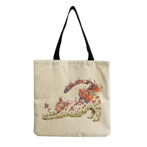 Close-up detail of the floral cat print canvas tote bag, featuring sturdy black handles.