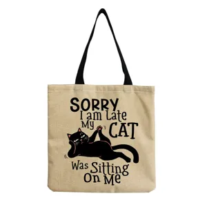 Detailed view of the casual canvas tote bag featuring cute black cat print and funny English quote.