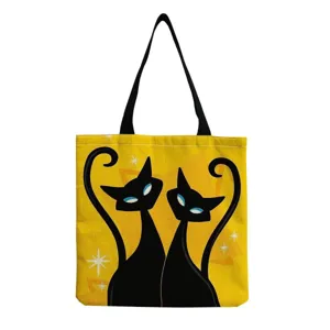 Detailed view of the retro style black cats print canvas tote bag with black handles.