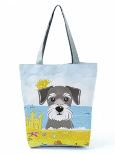 Close-up view of the cute cartoon schnauzer dog print on the canvas tote bag detail.