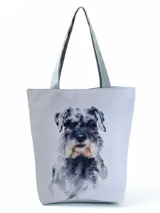 Close-up view of the watercolor Schnauzer dog print detail on the chic gray canvas tote bag.
