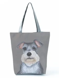 Detailed view of grey canvas tote bag with cute Schnauzer dog print and durable handles.