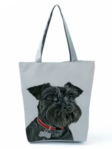 Detailed view of the stylish grey canvas tote bag with cute black dog print and red collar.