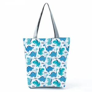 Vista dettagliata della borsa tote in tela con stampa dinosauro blu e manici grigi resistenti.
