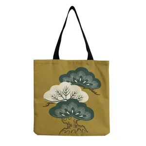 Japanese pine print canvas tote bag detail, featuring vintage tree pattern and black handles.
