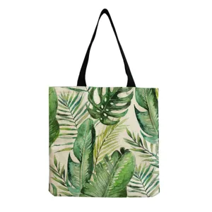 Dettaglio borsa shopper in tela con stampa acquerello di foglie tropicali, borsa botanica chic.