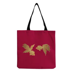 Goldfish print detail on red canvas tote bag, classic shoulder strap and large daily capacity.