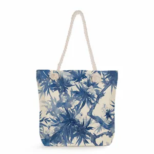 Primer plano del estampado botánico azul y blanco en lona con detalle de asa de cuerda.