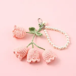 Handmade crochet flower keychain with elegant pearl strap cute bag charm accessory.