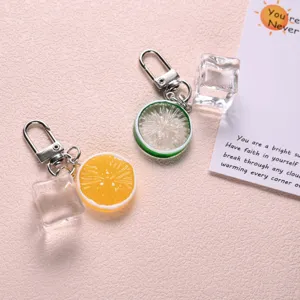 Close-up of cute lemon and ice cube keychain, sweet bag pendant accessory, detailed design.
