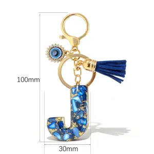 Porte-clés lettre J bleue avec breloque mauvais œil et pompon en cuir, 100x30mm.